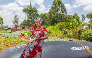 Female farmer in Kenya using HomeBiogas small-scale biogas system – HomeBiogas